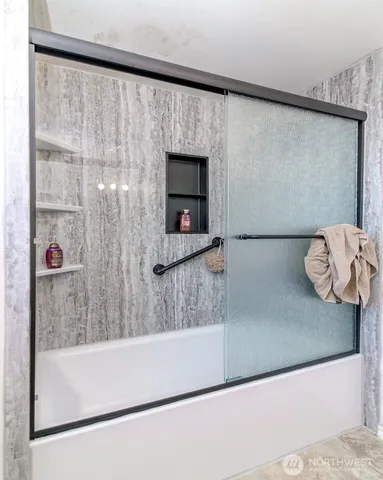 a bathroom with a bathtub and a shower