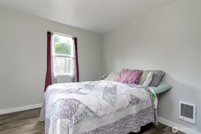 a bed sitting in a bedroom next to a window