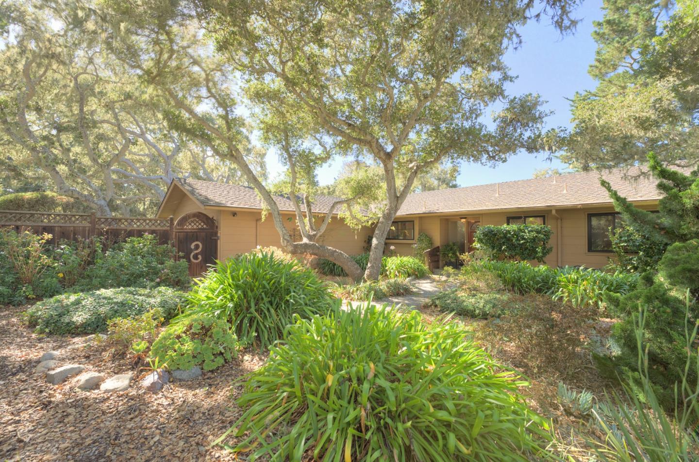 3084 Sloat Road Pebble Beach, CA 93953 - Photo 1 of 38 a front view of a house with garden