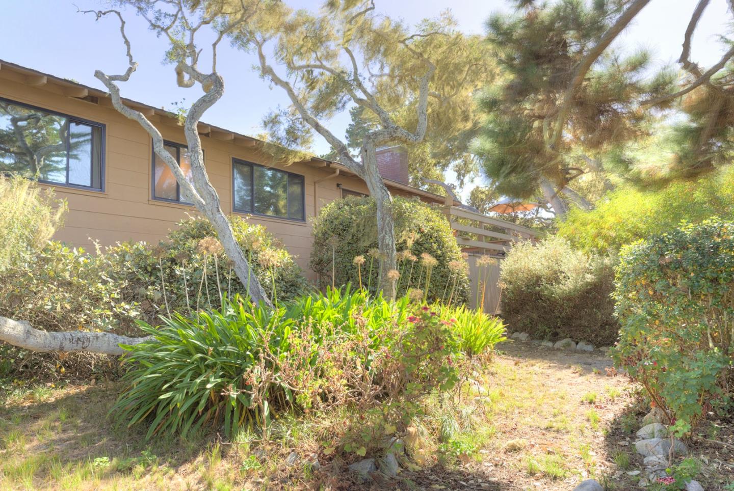 3084 Sloat Road Pebble Beach, CA 93953 - Photo 12 of 38 a yellow building with trees in front of it