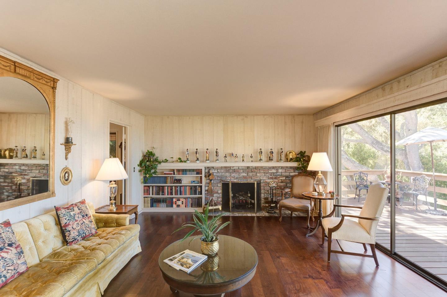 3084 Sloat Road Pebble Beach, CA 93953 - Photo 3 of 38 a living room with furniture a fireplace and a table