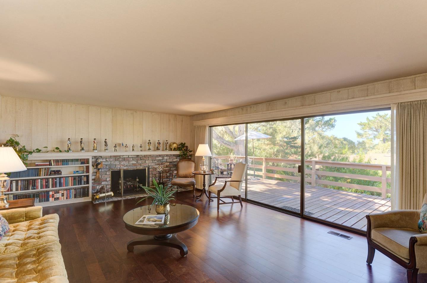 3084 Sloat Road Pebble Beach, CA 93953 - Photo 8 of 38 a living room with furniture a fireplace and a floor to ceiling window
