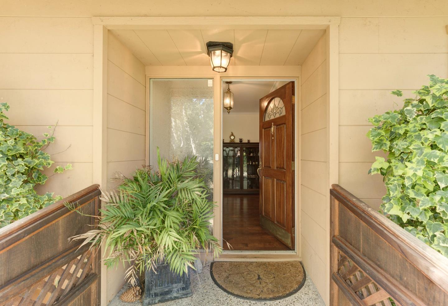 3084 Sloat Road Pebble Beach, CA 93953 - Photo 9 of 38 a glass door with potted plants in front of it