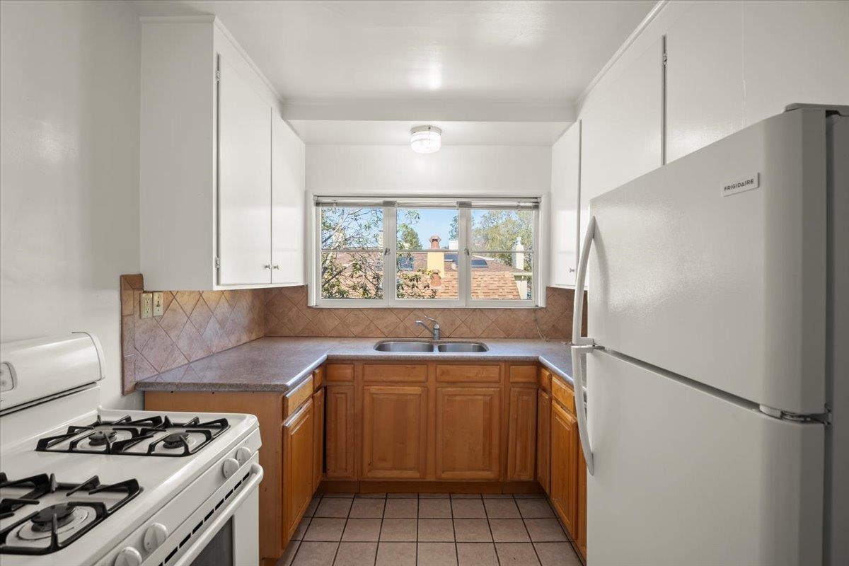 1526 Arch Street Berkeley, CA 94708 - Photo 12 of 27 a kitchen with a sink a refrigerator and a stove