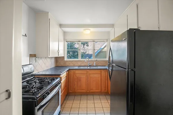 a kitchen with a refrigerator a sink and a stove