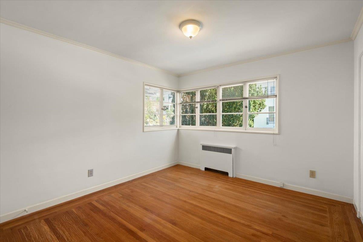 1526 Arch Street Berkeley, CA 94708 - Photo 19 of 27 an empty room with wooden floor and windows