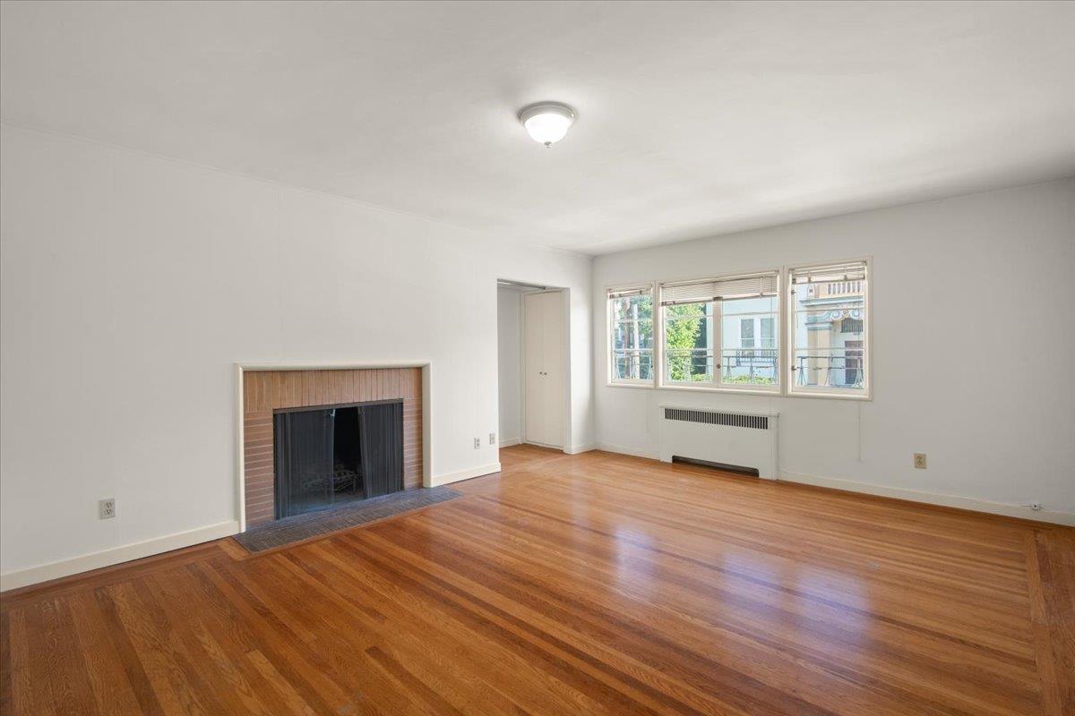 1526 Arch Street Berkeley, CA 94708 - Photo 20 of 27 wooden floor fireplace and windows in an empty room