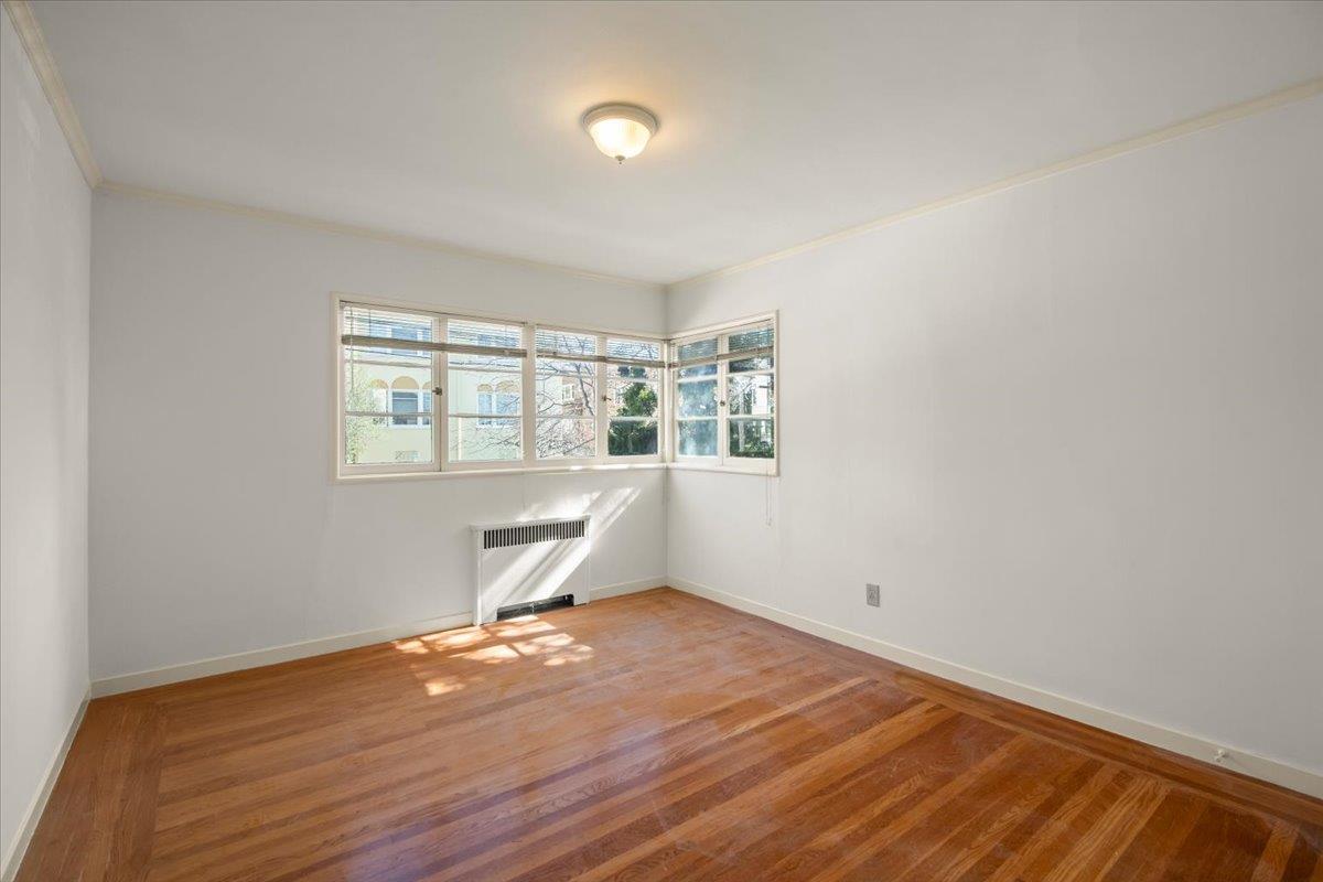1526 Arch Street Berkeley, CA 94708 - Photo 21 of 27 an empty room with wooden floor and windows