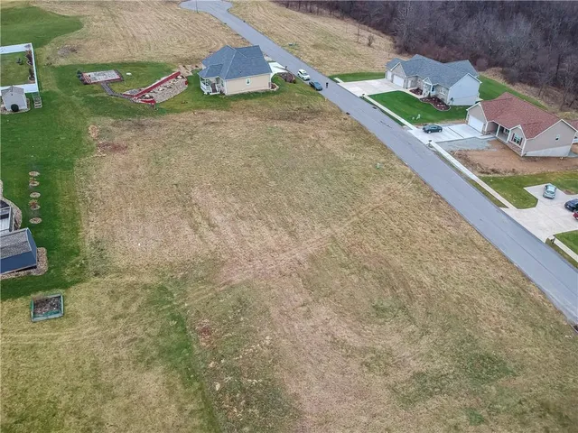 an aerial view of a house with a yard