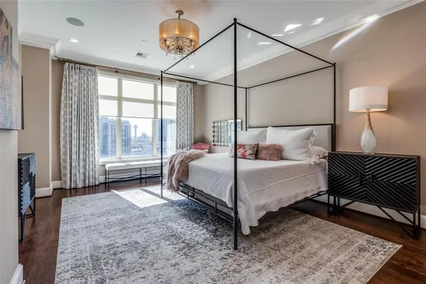 a bedroom with a bed window and a table in it