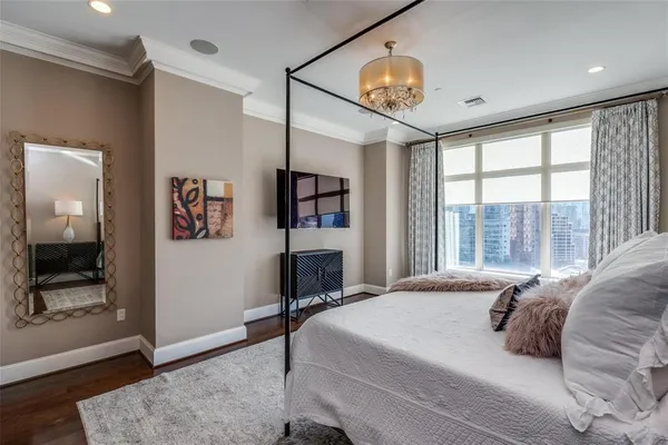 a bedroom with a large bed and a large window