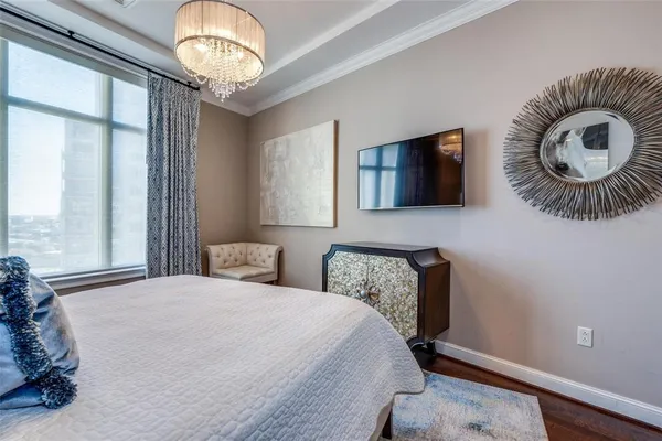 a bedroom with a bed and a chandelier