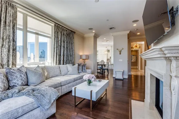 a living room with furniture a fireplace and a large window