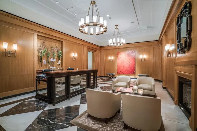 a living room with furniture a chandelier and a large window