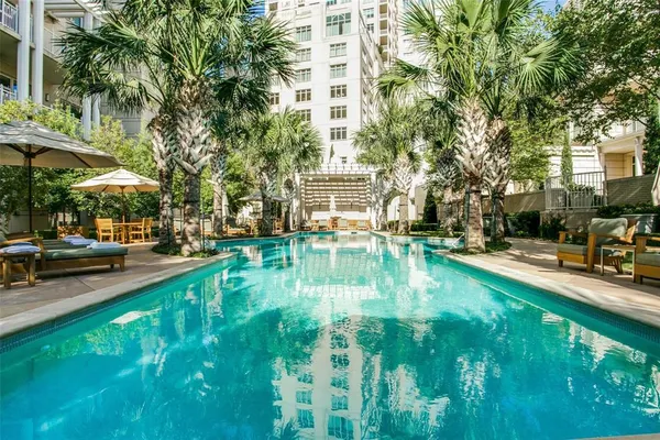 a view of yard with swimming pool and trees in the background