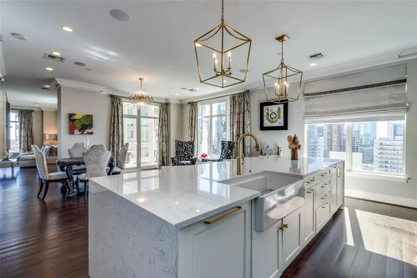 a large kitchen with granite countertop a large center island attached withe living room