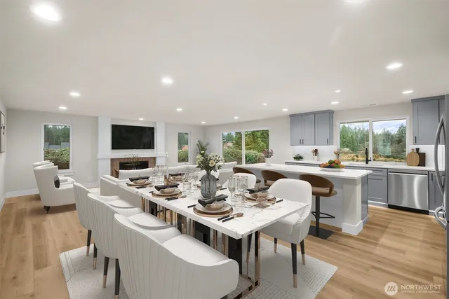 a kitchen with kitchen island a counter top space a refrigerator cabinets and a large window