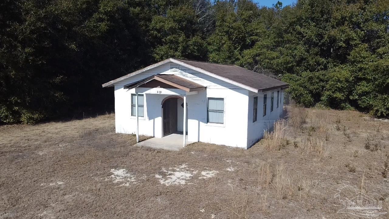 2360 Highway 4 Century, FL 32535 - Photo 1 of 12 a front view of a house with a yard and garage
