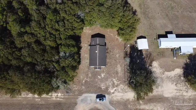 an aerial view of a house with a yard