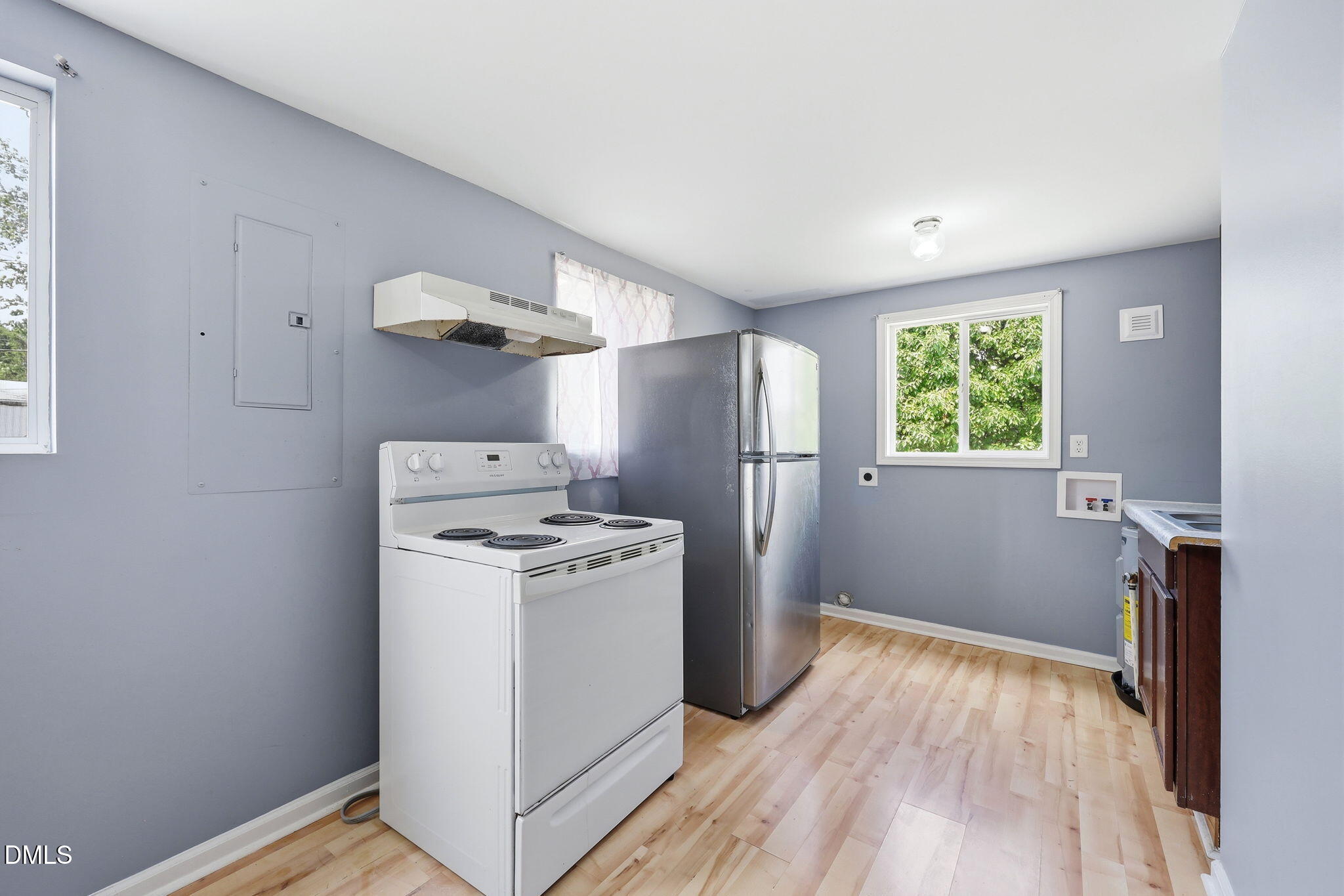 1758 Barber Mill Road Clayton, NC 27520 - Photo 13 of 41 a view of a kitchen with a stove wooden floor and a window