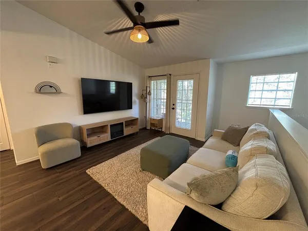 a living room with furniture and a flat screen tv