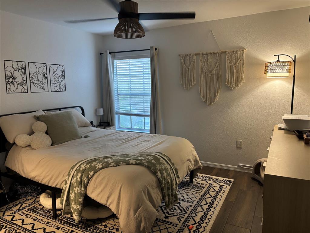 8809 Manor Loop, Unit 202 Lakewood Ranch, FL 34202 - Photo 5 of 9 a bedroom with a bed and wooden floor
