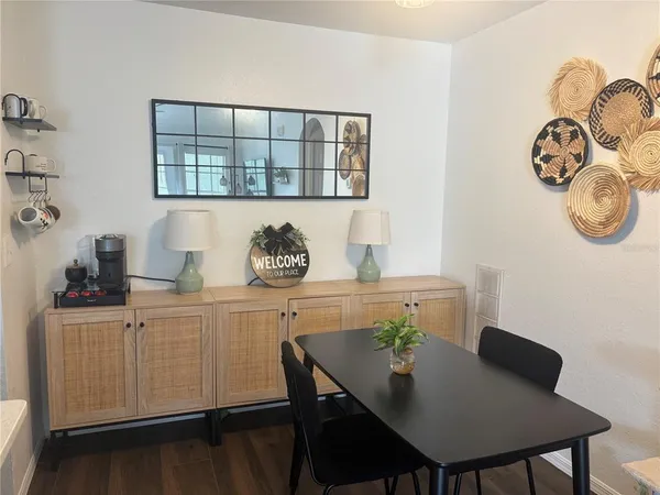 a view of a dining room with furniture and wooden floor