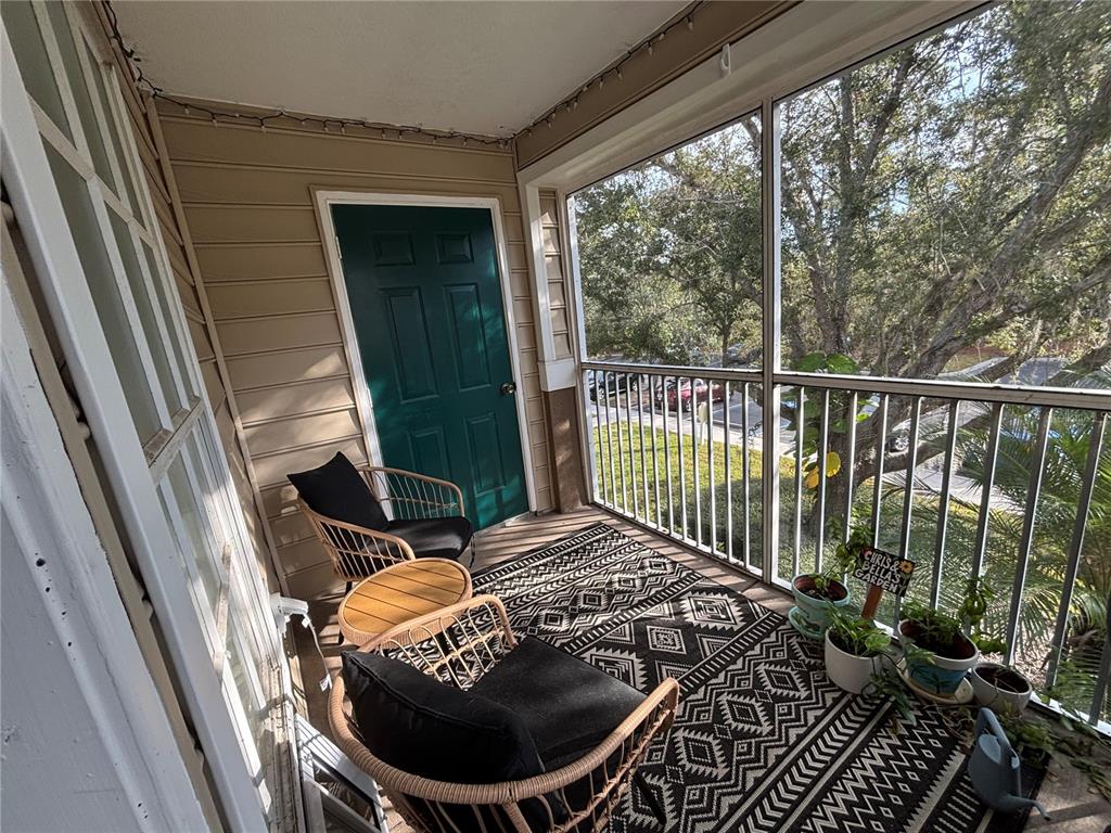 8809 Manor Loop, Unit 202 Lakewood Ranch, FL 34202 - Photo 8 of 9 a balcony with table and chairs