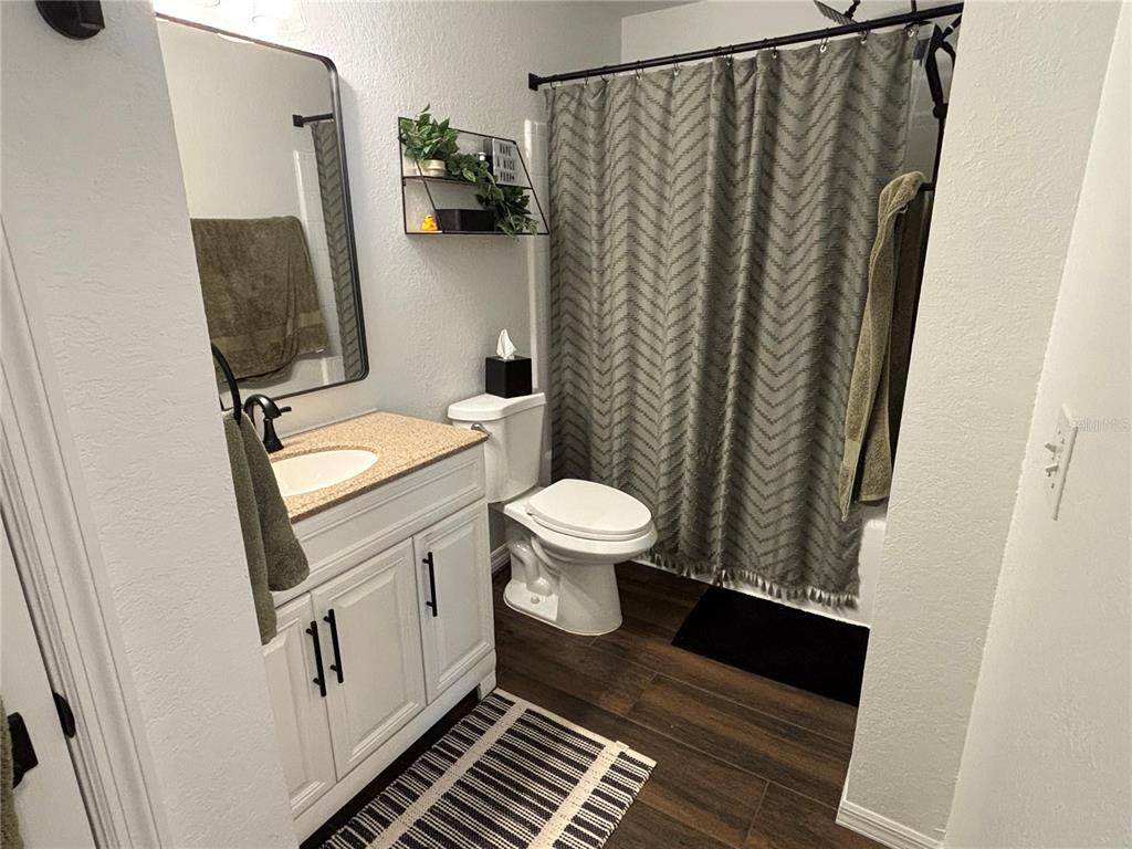8809 Manor Loop, Unit 202 Lakewood Ranch, FL 34202 - Photo 9 of 9 a bathroom with a sink and a mirror