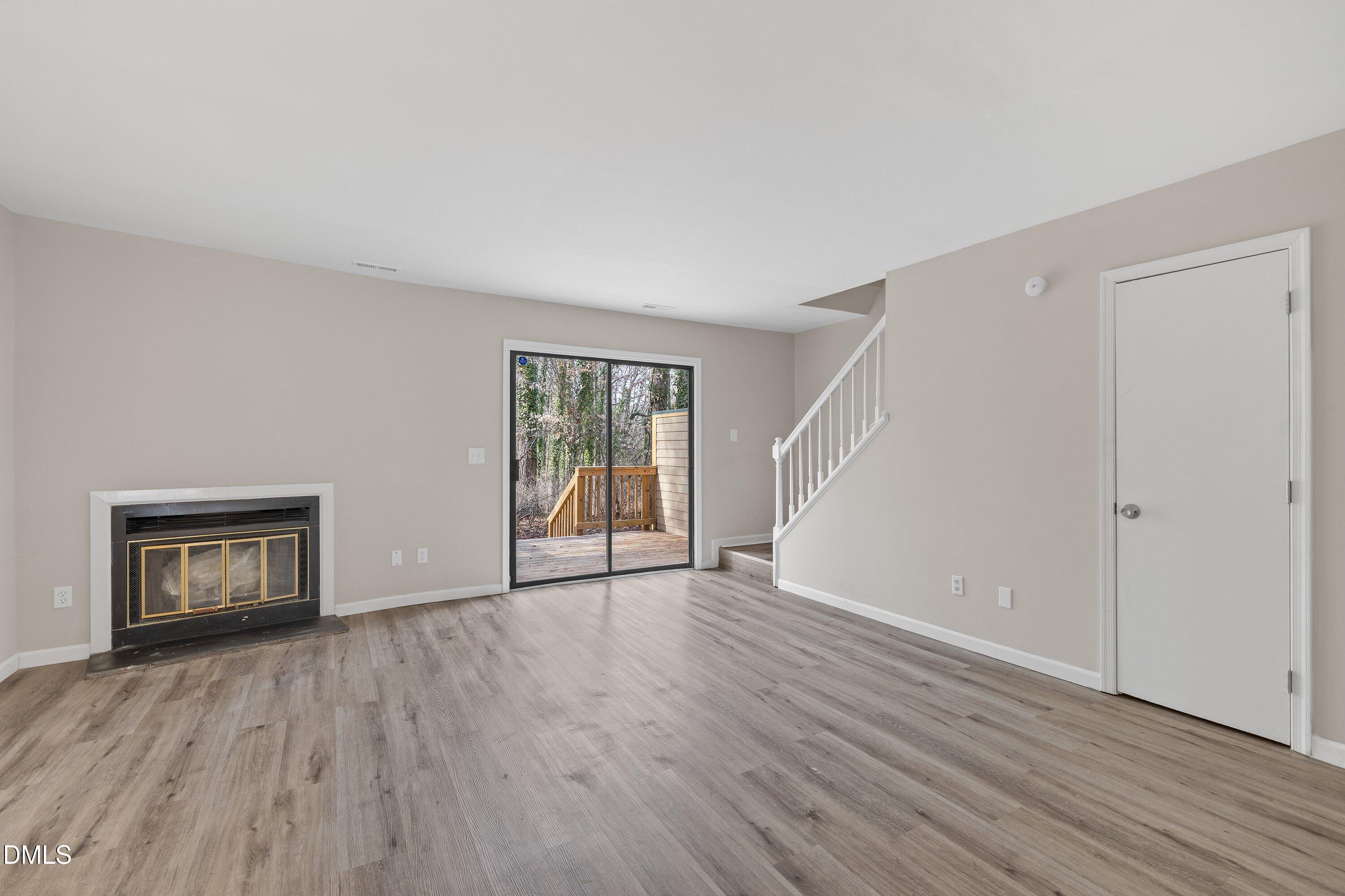 887 Dalewood Drive Raleigh, NC 27610 - Photo 10 of 21 a view of an empty room with wooden floor and a window