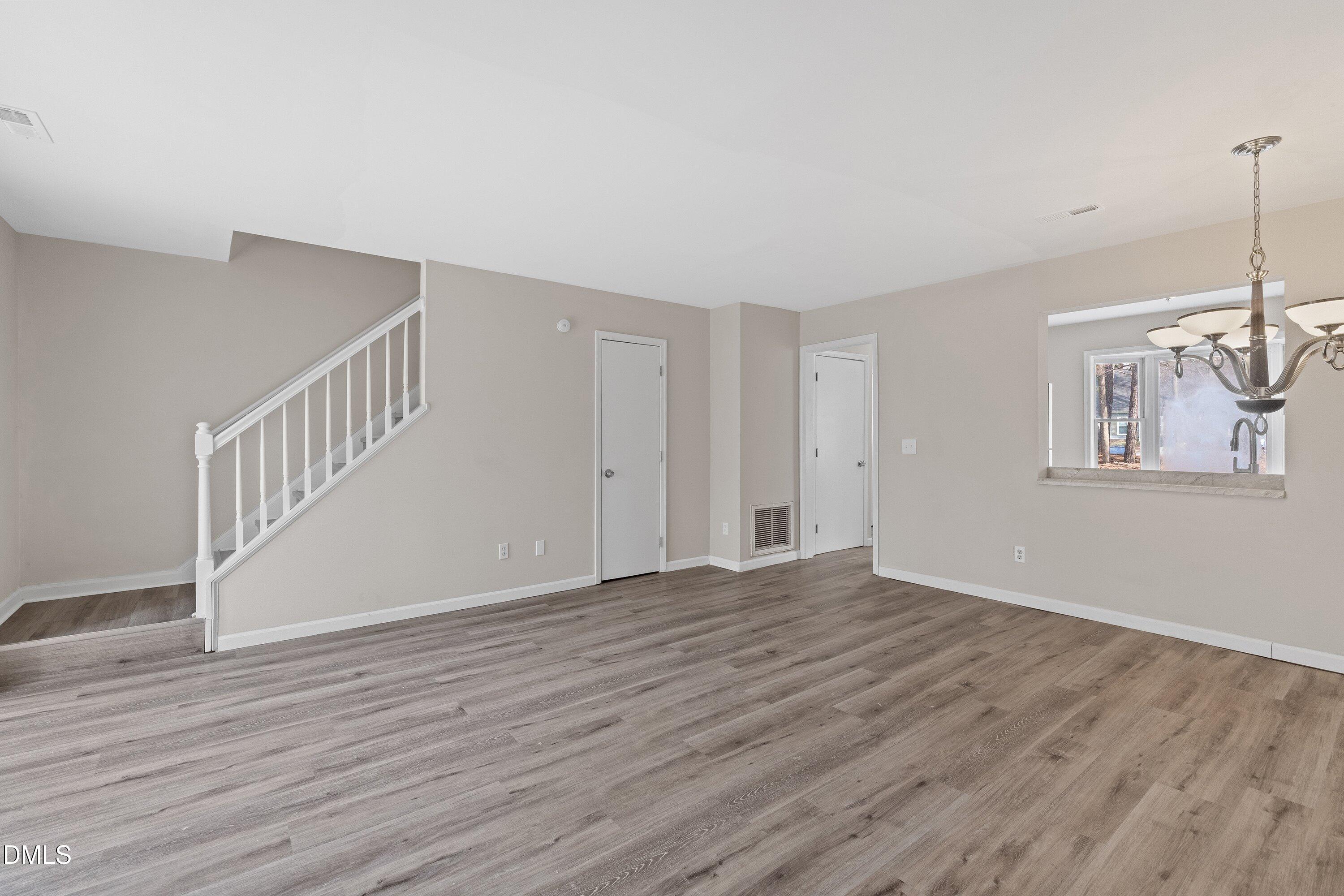 887 Dalewood Drive Raleigh, NC 27610 - Photo 11 of 21 a view of an empty room with wooden floor and a window