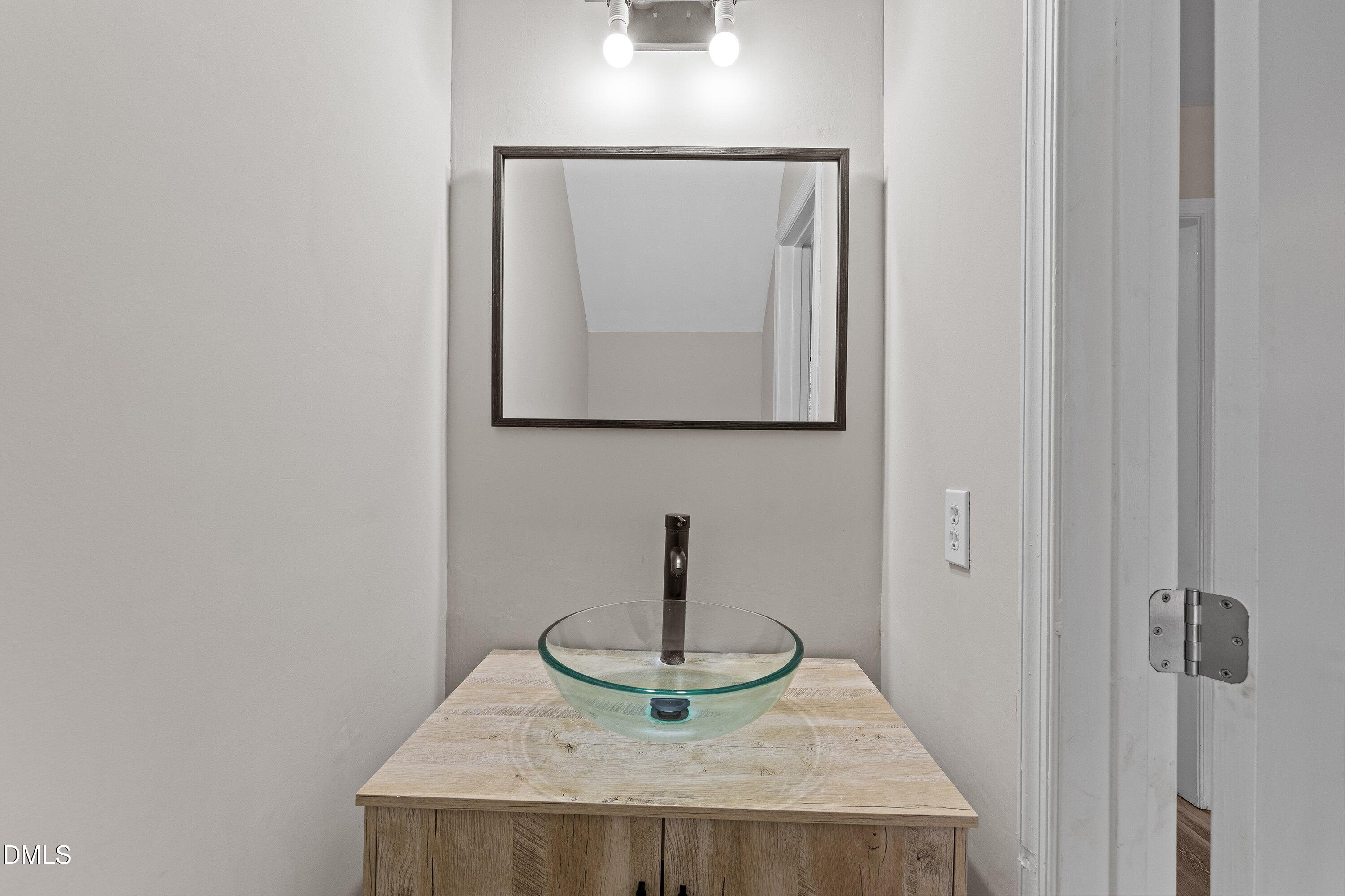 887 Dalewood Drive Raleigh, NC 27610 - Photo 12 of 21 a bathroom with a sink and a mirror