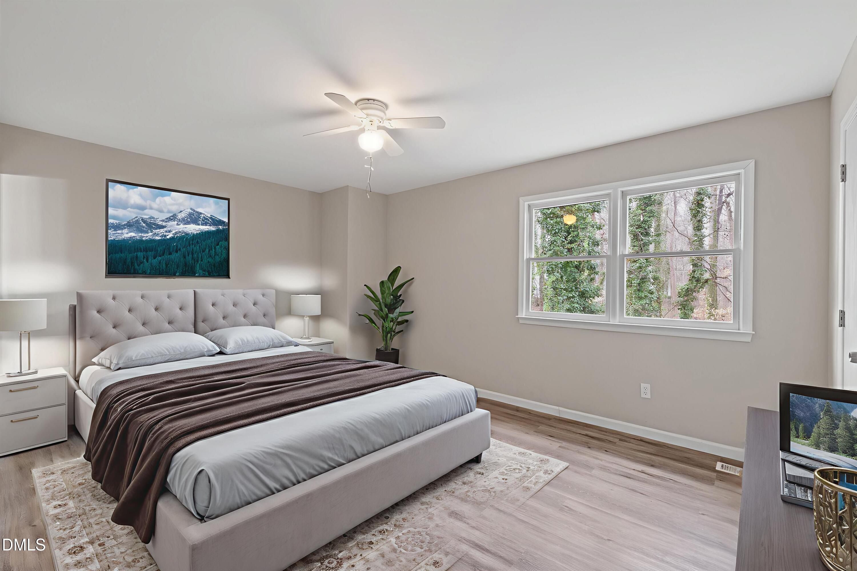 887 Dalewood Drive Raleigh, NC 27610 - Photo 13 of 21 a bedroom with a large bed and a window