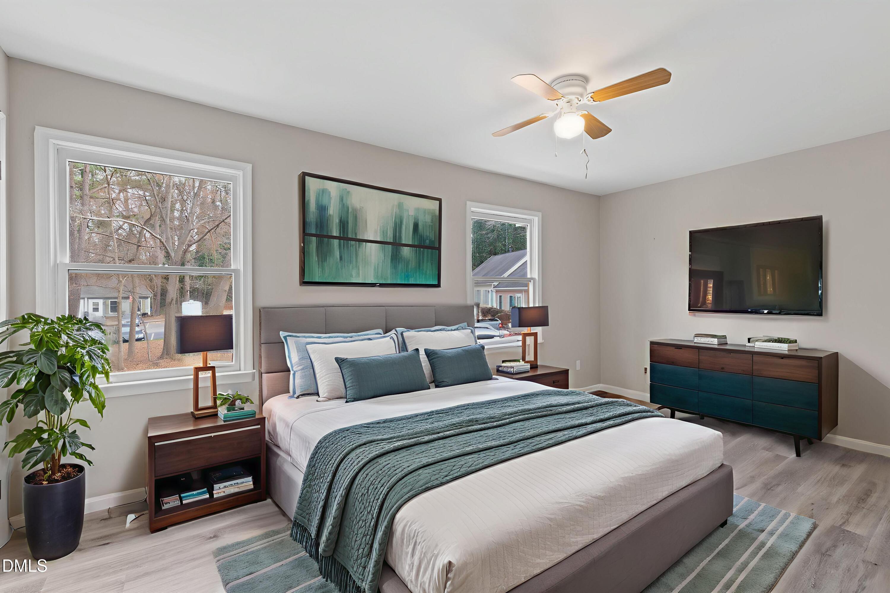 887 Dalewood Drive Raleigh, NC 27610 - Photo 15 of 21 a bedroom with a balcony a bed and a flat screen tv