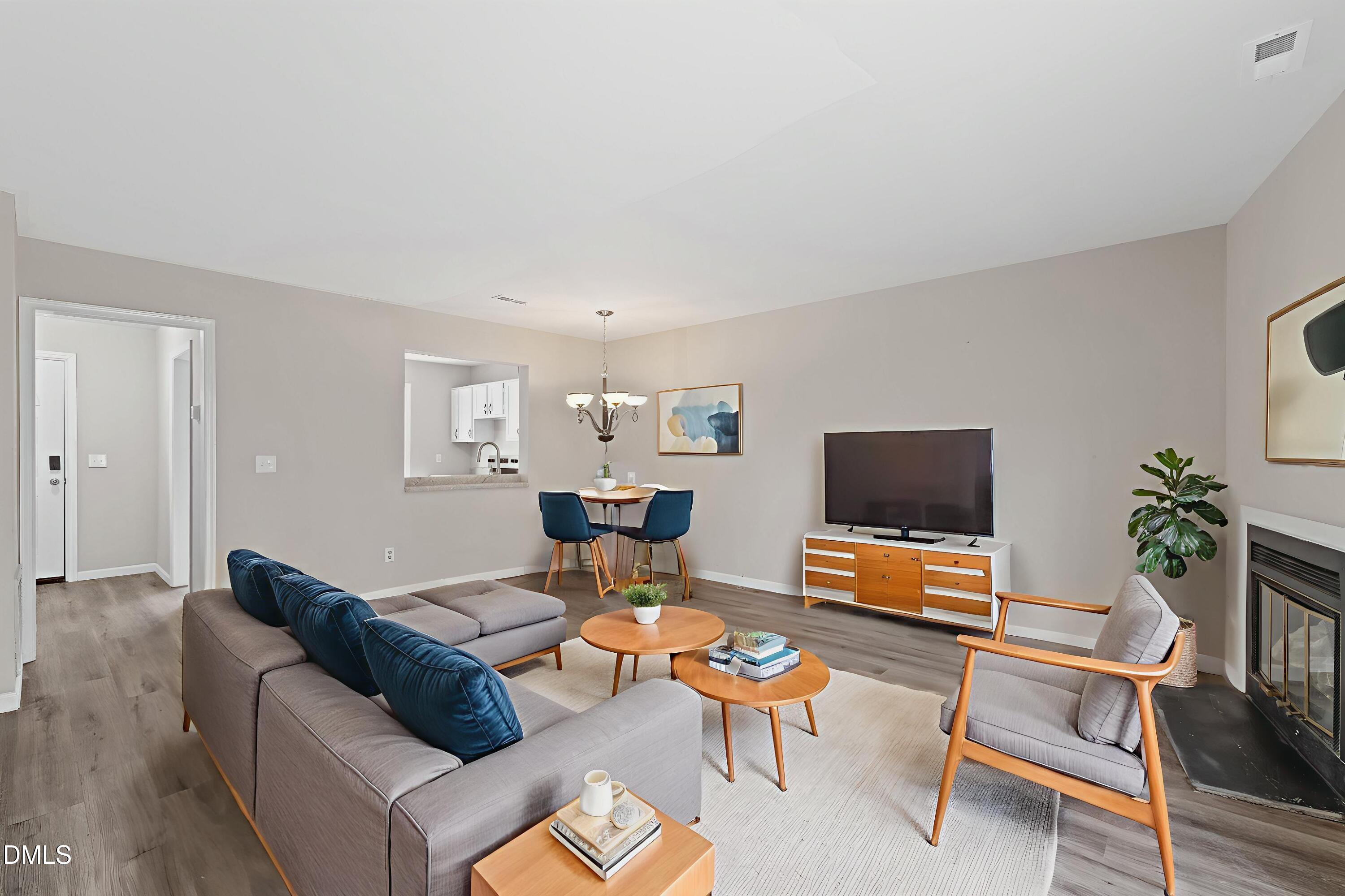 887 Dalewood Drive Raleigh, NC 27610 - Photo 3 of 21 a living room with furniture and a flat screen tv