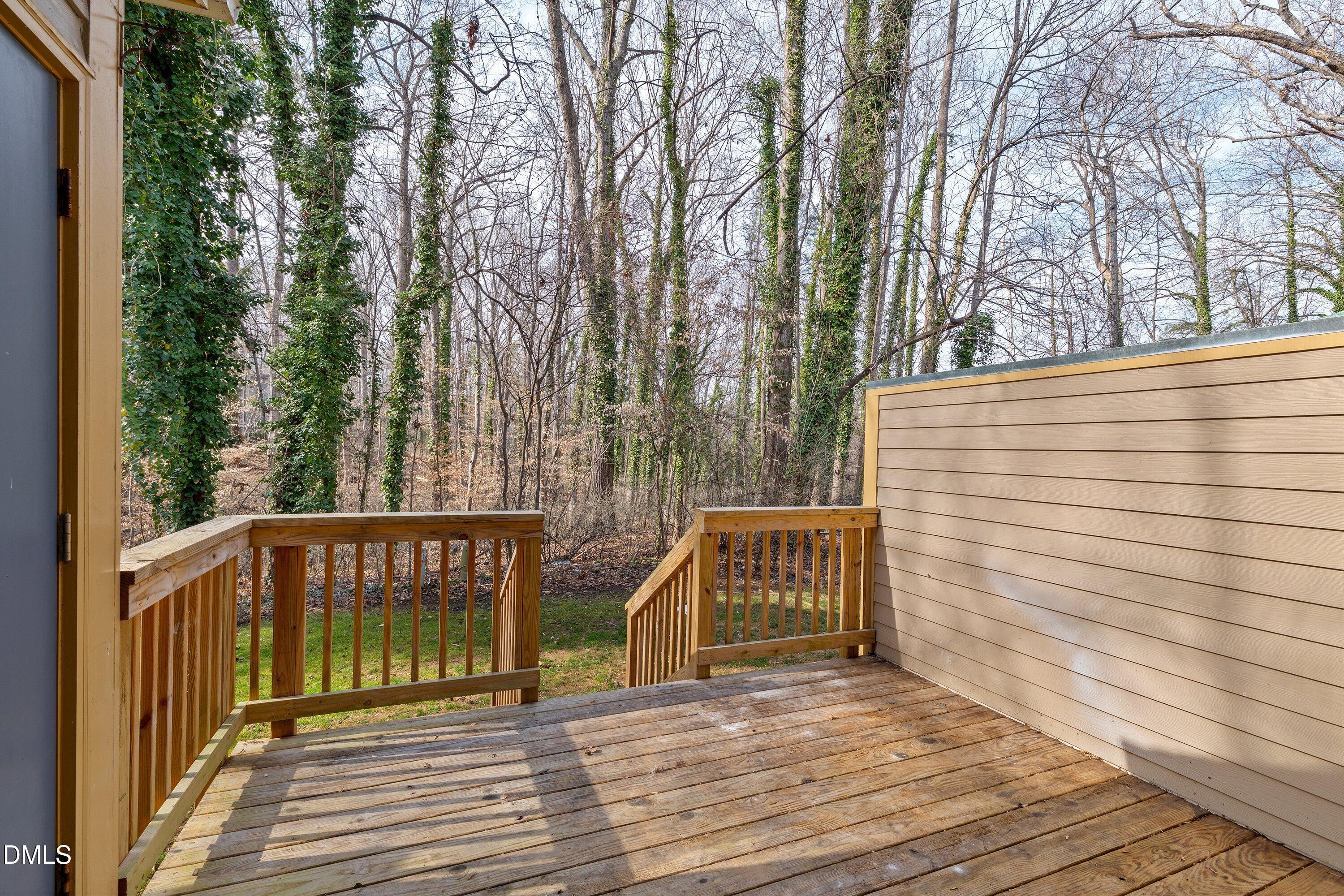 887 Dalewood Drive Raleigh, NC 27610 - Photo 4 of 21 a view of a wooden deck with trees