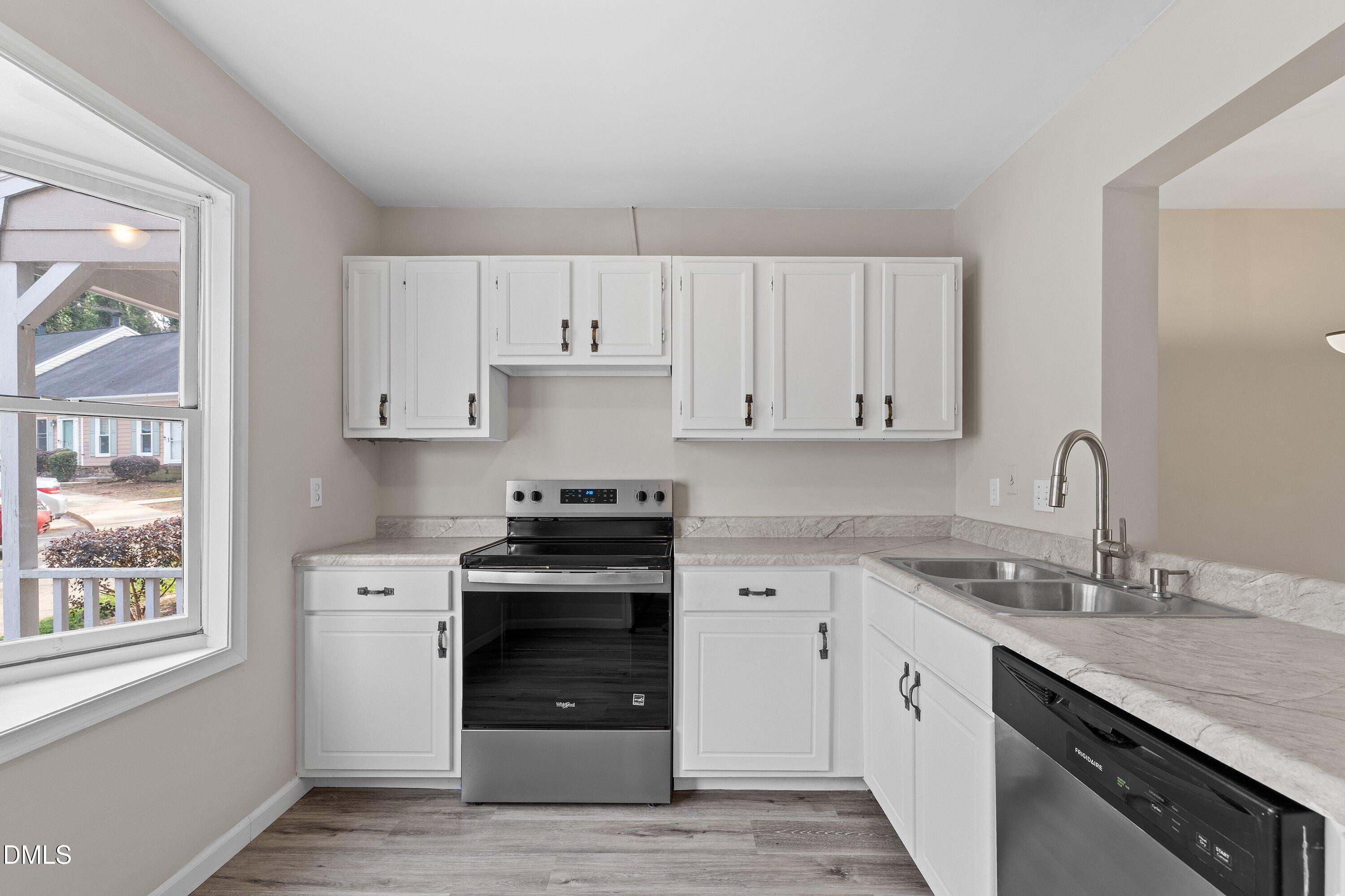 887 Dalewood Drive Raleigh, NC 27610 - Photo 5 of 21 a kitchen with granite countertop white cabinets and stainless steel appliances