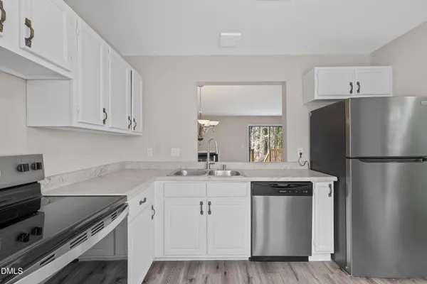a kitchen with appliances cabinets and a stove top oven