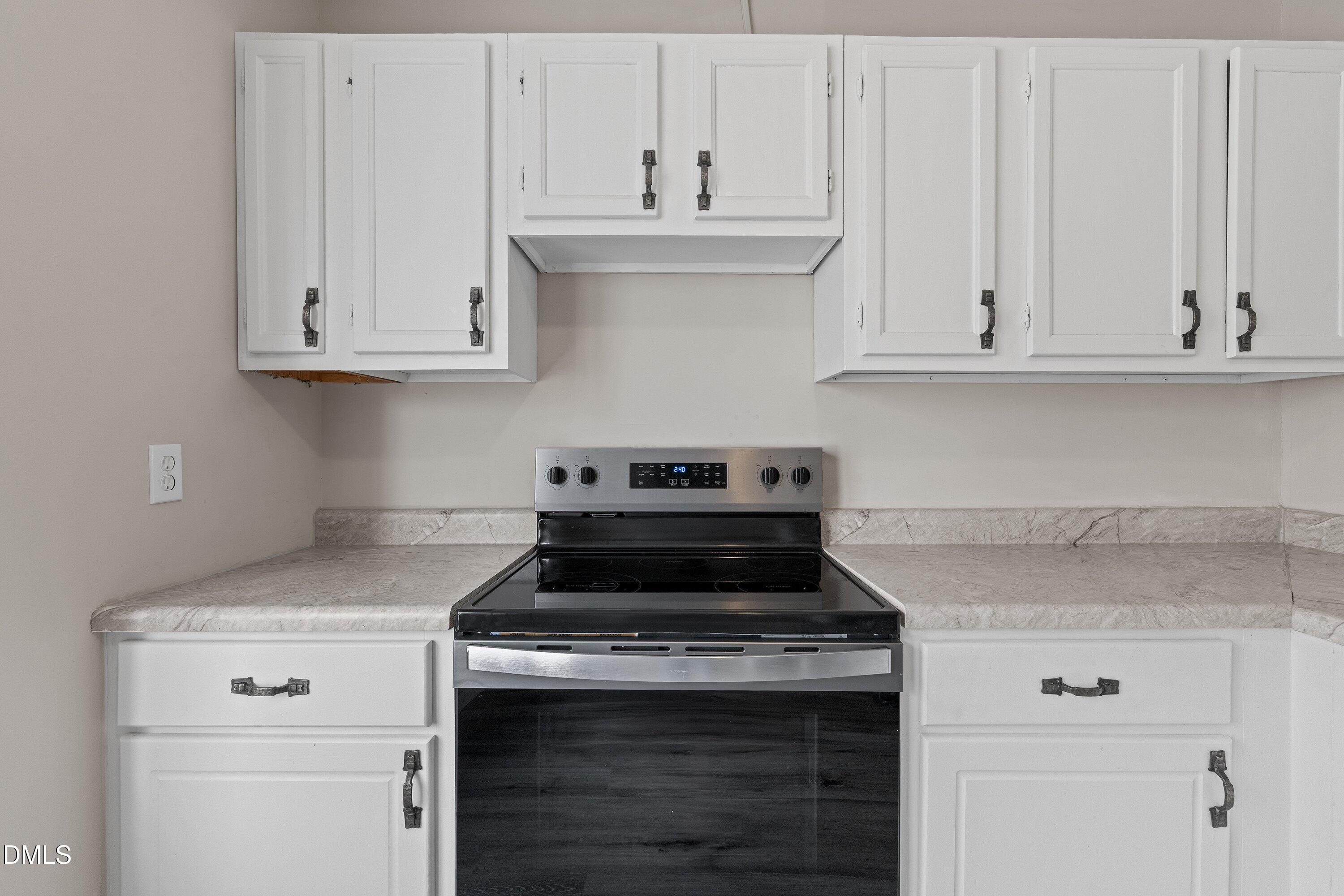 887 Dalewood Drive Raleigh, NC 27610 - Photo 7 of 21 a stove top oven sitting inside of a kitchen