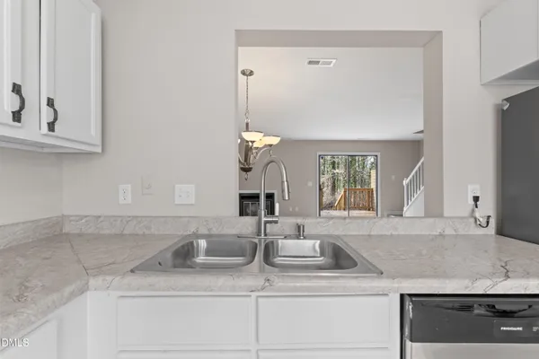 a stove top oven sitting inside of a kitchen