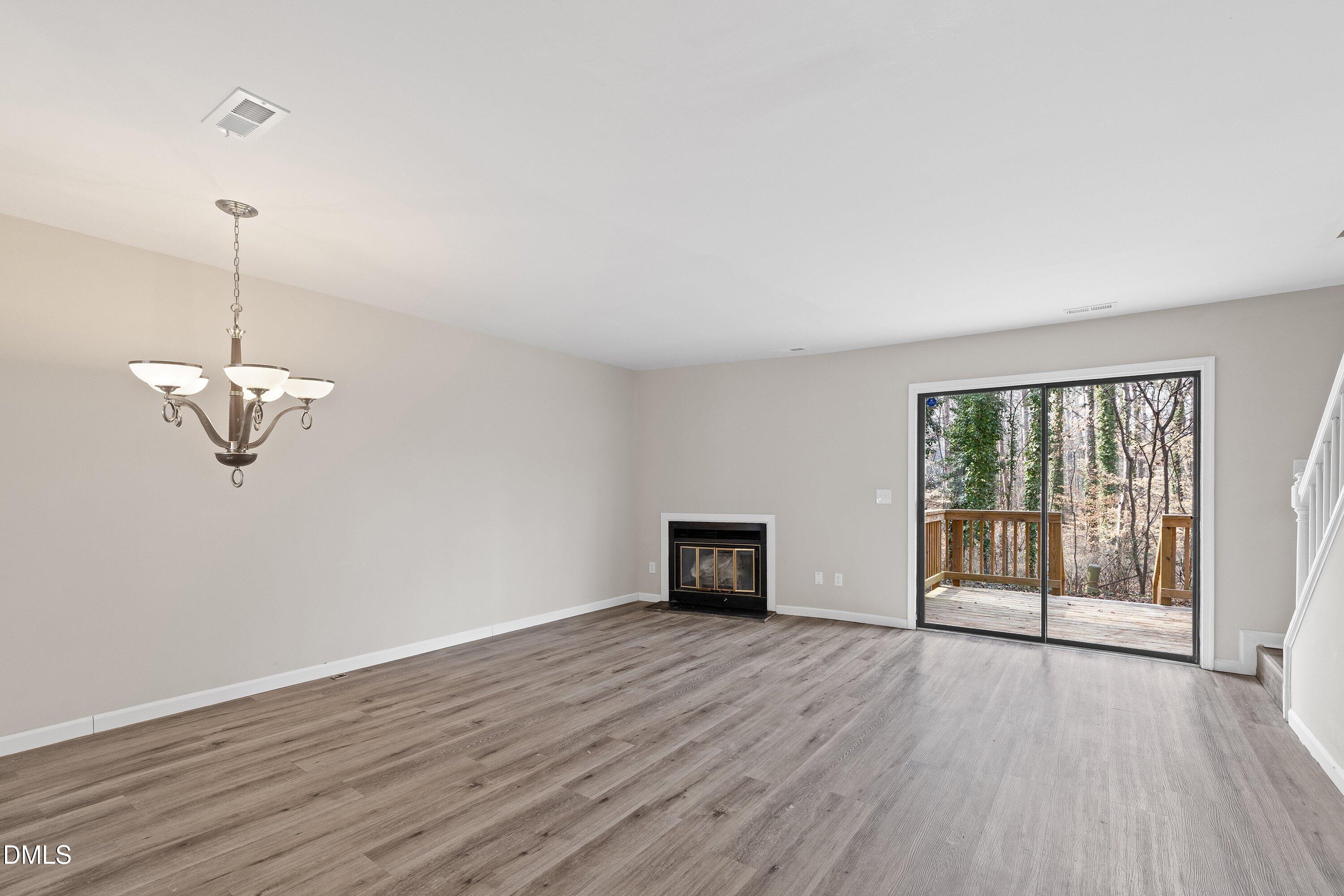 887 Dalewood Drive Raleigh, NC 27610 - Photo 9 of 21 a view of empty room with wooden floor and fan