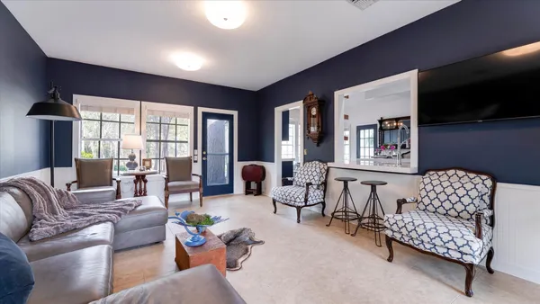 a living room with furniture a fireplace and a flat screen tv