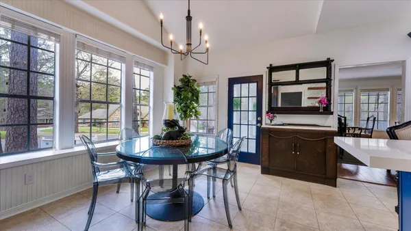 a living room with furniture or couch and a chandelier