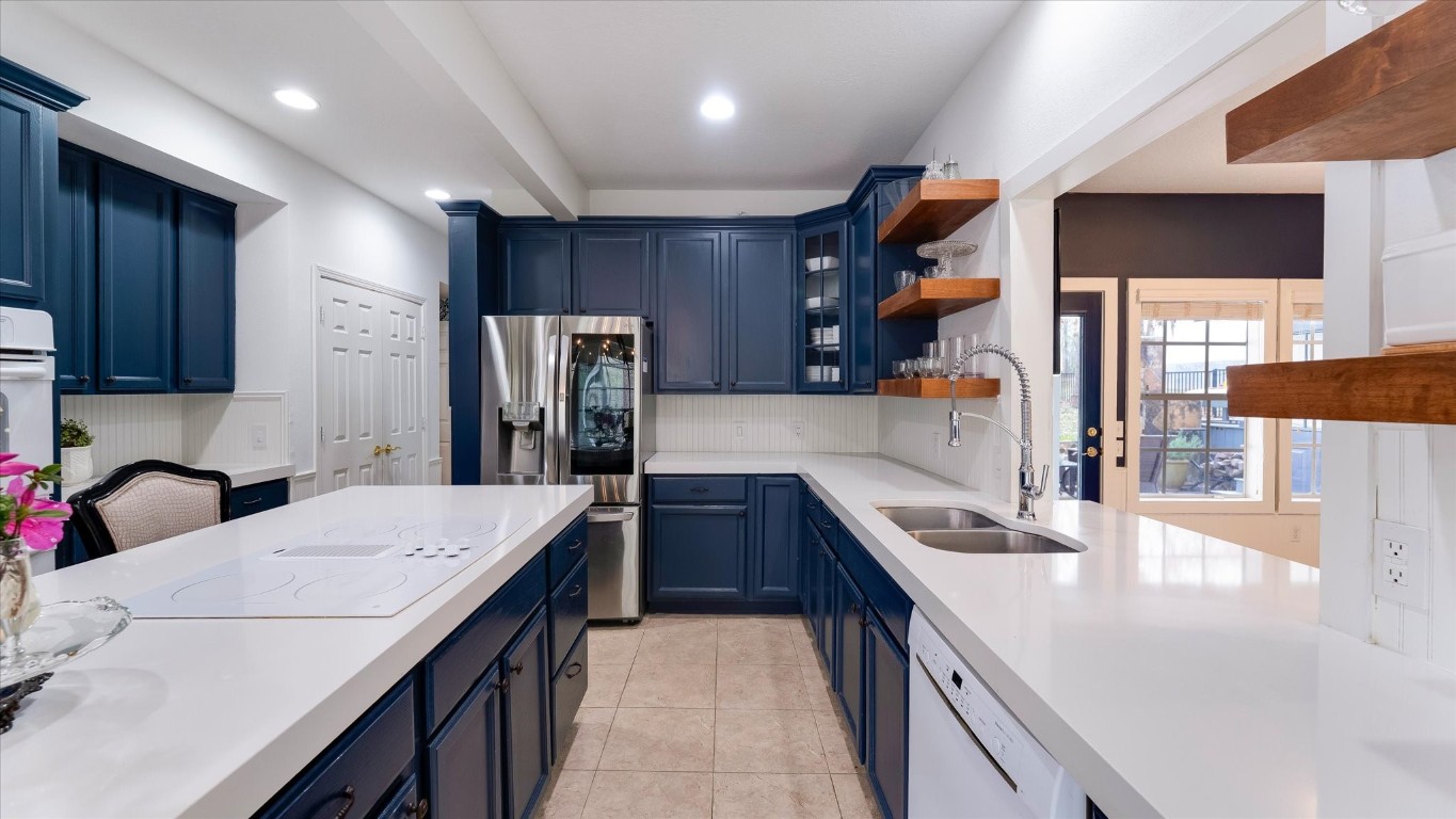 100 Lords Circle Coldspring, TX 77331 - Photo 16 of 50 a kitchen with stainless steel appliances granite countertop a sink a stove and a refrigerator