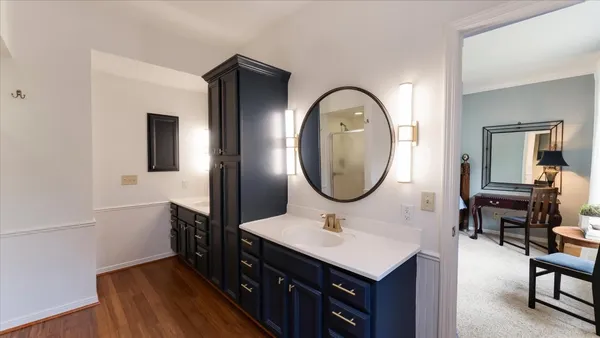 a bedroom with two beds and a chandelier