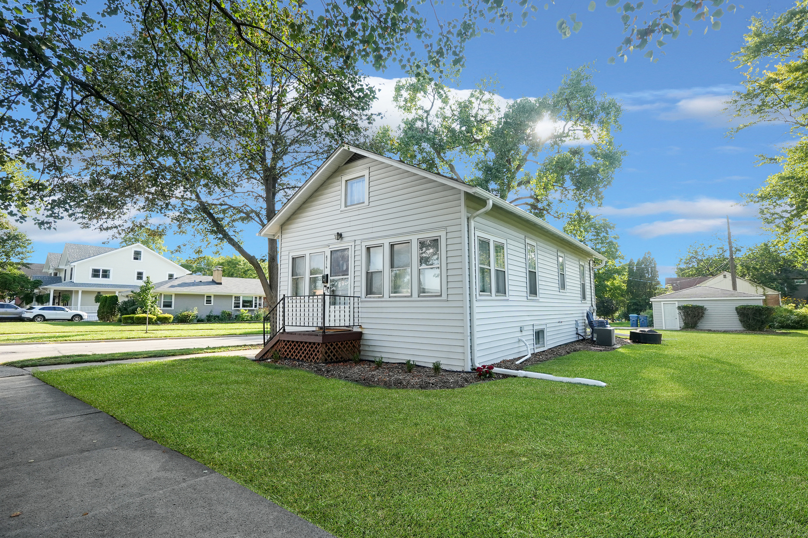 4716 Douglas Road Downers Grove, IL 60515 - Photo 14 of 18 a front view of a house with a garden