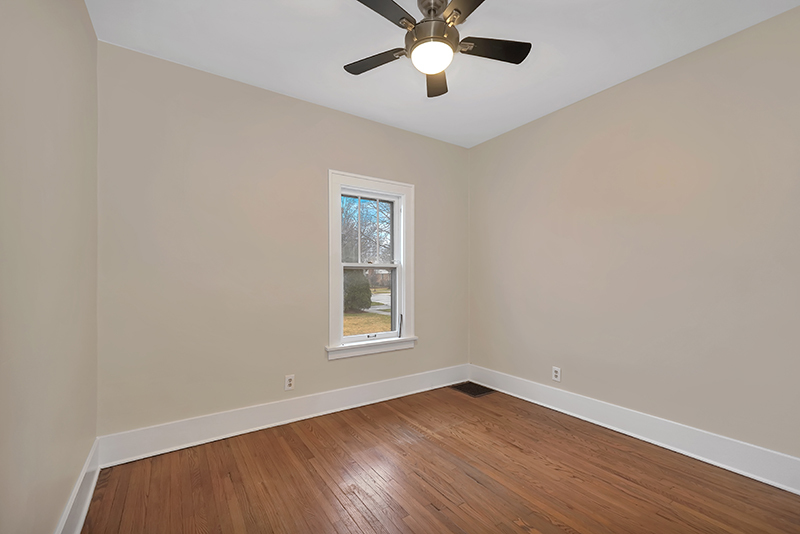 4716 Douglas Road Downers Grove, IL 60515 - Photo 10 of 18 an empty room with wooden floor fan and windows