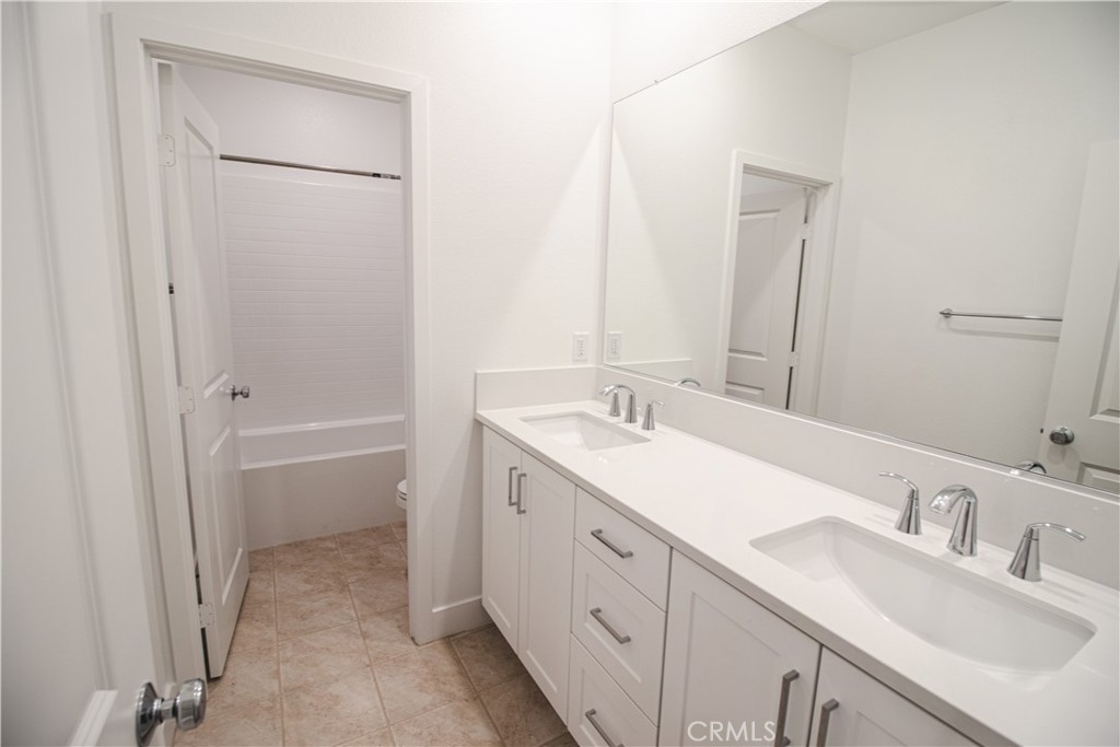 635 Gadwall Irvine, CA 92618 - Photo 11 of 27 a bathroom with a sink and a mirror