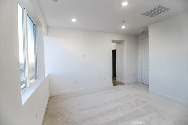 an empty room with windows and closet