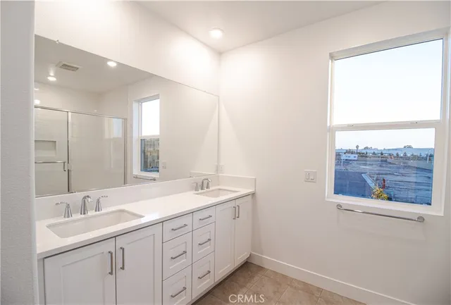 a spacious bathroom with a double vanity sink and a mirror